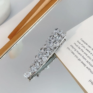 Detail view of silver hair clip with micro-set teardrop and round marquise zircons