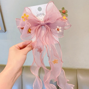 Pink mesh hair bow for girls with colorful floral embroidery on a decorative card