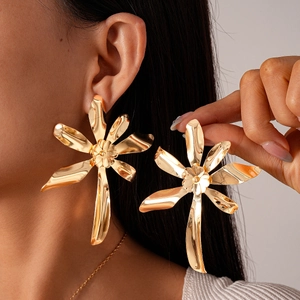 Dramatic gold oversized flower earrings featuring artistic petal design for a bold statement