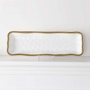 Detailed view of rectangular white ceramic tray with elegant gold beaded rim design