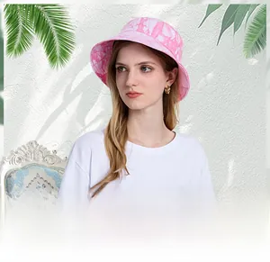 Close-up detail of pink tie-dye fabric and wide brim design on this summer sun bucket hat