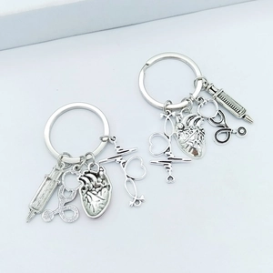 Detailed close-up of medical keychain with heart, stethoscope and syringe pendants