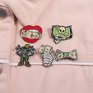 Detail of 5-piece pop art enamel pins set showing skull and currency designs on corduroy