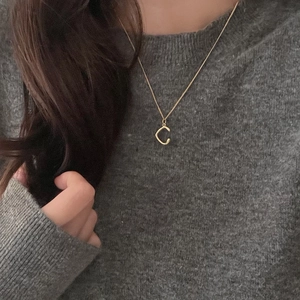 Minimalist 925 sterling silver gold plated letter C necklace on grey knit sweater