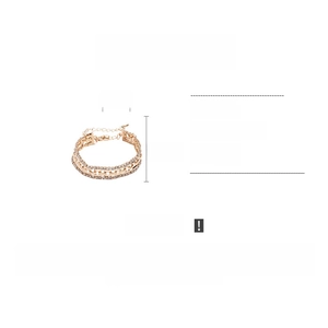 Detail view of gold rhinestone bracelet measuring 1.1cm wide and 23.7cm long
