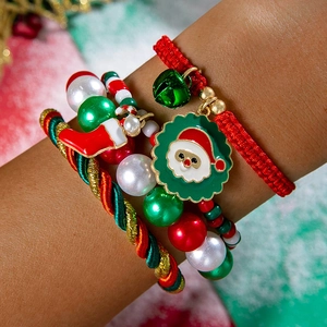 Macro view of Christmas red and green braided ropes with Santa Claus and bell pendants