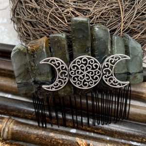 Macro view of Labradorite stones and moon goddess symbol on a silver metal hair comb