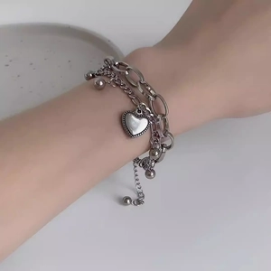 Double-layered silver heart pendant bracelet with mixed chains and metal beads for women
