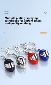 Detail of four colorful mini 3D motorcycle helmet keychains with metallic finish