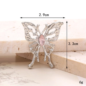 Silver hollow bow shoe charm with pink gemstone on marble background measuring 3.3cm
