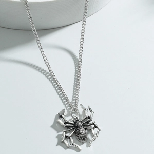 Gothic silver spider pendant necklace with detailed textured legs on a metal link chain