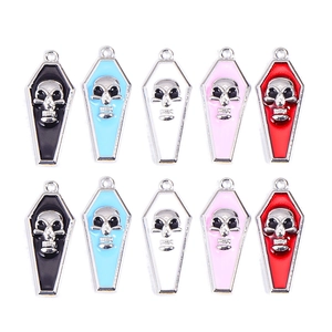 Detail of colorful vampire coffin skull pendants in alloy and enamel for DIY jewelry