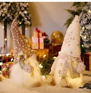Macro detail of glowing Christmas gnomes with knit hats and warm LED lights