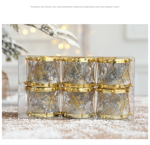 Set of 6 gold and silver Christmas drum ornaments shown in a festive snowy scene background