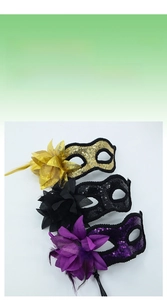 Detail of masquerade masks with sequins, feathers, and side flowers in gold, black, and purple