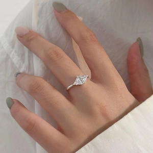 Elegant 925 sterling silver ring with rhombus-cut zircon stones on model's hand