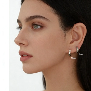 Close-up of S925 sterling silver hoop earrings in 8mm and 10mm sizes on female model