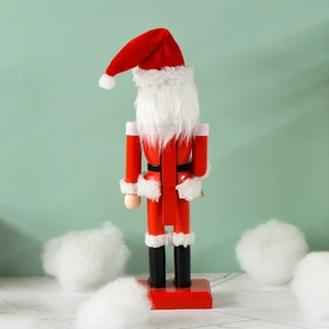 25cm red Santa Claus nutcracker figurine holding a bell on a snowy festive background