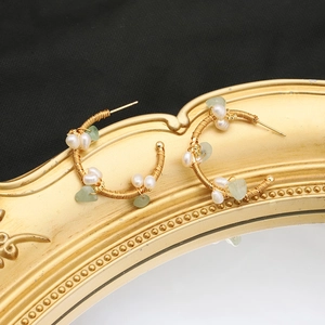 Handmade gold wire-wrapped hoop earrings with natural pearls and light green stones