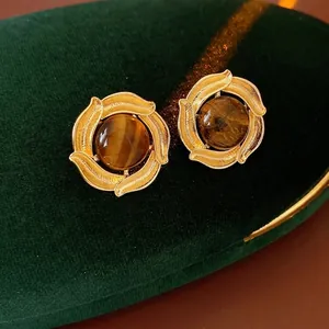 Vintage gold hoop earrings with brown tiger eye stone and elegant leaf texture
