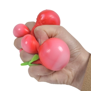 Squeezable strawberry stress relief toy with soft texture held in hand on white background