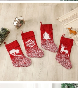 Set of 4 red knitted Christmas stockings with snowflake, deer, cabin and tree patterns