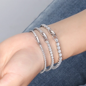 Close-up of S925 sterling silver tennis bracelets with 4mm cubic zirconia on denim background