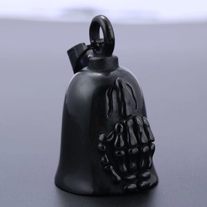 Detailed view of black motorcycle bell pendant with middle finger skull embossing