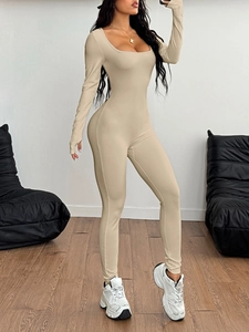 Detail of ribbed knit beige yoga bodysuit featuring long sleeves and thumbhole design