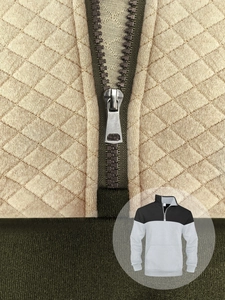 Detailed close-up of half-zip collar and quilted diamond pattern on waffle knit sweatshirt
