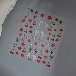 Detailed sheet of 3D embossed nail stickers featuring red flowers and cherry designs
