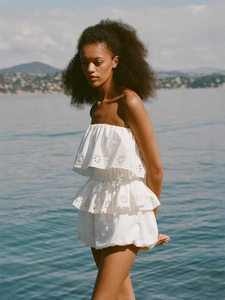 White eyelet embroidery tiered ruffle tube top and shorts set for women on outdoor beach