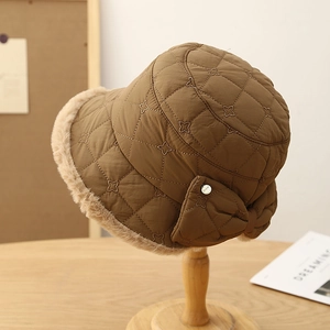Quilted winter bucket hat in deep brown with faux fur trim and bow detail decoration