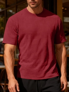 Close-up of slim fit burgundy t-shirt featuring premium textured jacquard fabric