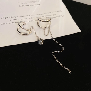 Detail of silver ear cuff with long tassel chain and dark faceted crystal bead