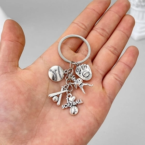 Silver softball keychain with glove bat and I Love Softball charms held in palm