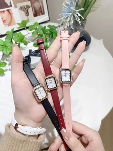 Detail view of colorful leather strap watches with rectangular diamond-encrusted dials