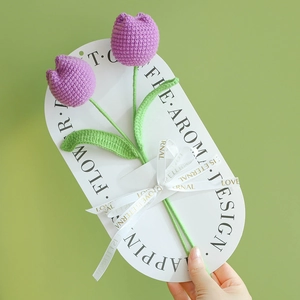 Handmade crochet tulip bouquet with purple petals and green stems on white card
