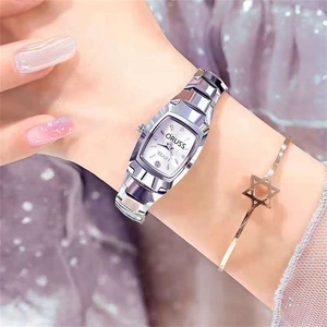 Detail of tonneau silver quartz watch with diamond markers on sparkling purple fabric