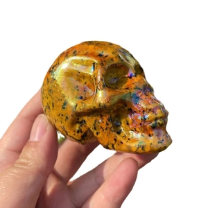 7cm Aura crystal skull carving with natural yellow rainbow gemstone and black spots finish