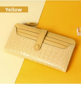 Close-up of yellow leather long purse featuring luxury embossed crocodile pattern details
