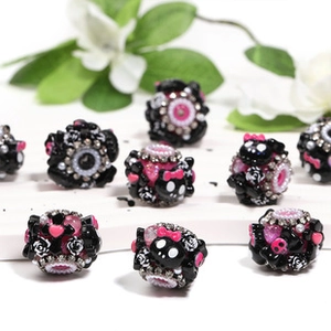 Detail of black beads with pink bows and skulls for DIY Christmas phone chain accessories