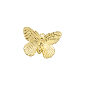 Macro detail of a vintage gold-plated butterfly pendant with textured wings and top ring
