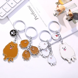 Detail view of enamel Pomeranian dog keychains with I Heart Dogs and paw print charms