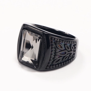 Macro shot of black titanium ring with rectangle gemstone and hollow pattern