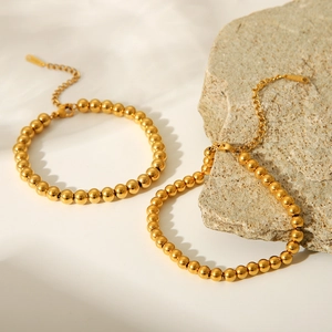 Detail of 18K gold-plated stainless steel bead bracelets with adjustable lobster clasp