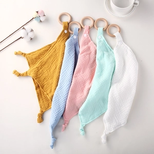 Five assorted cotton gauze baby security blankets with wooden teething rings and snaps