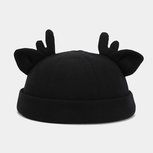 Detail of black brimless docker cap featuring 3D reindeer antler and ear decorations