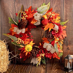 Rustic autumn door wreath with red sunflowers maple leaves pine cones and pumpkins
