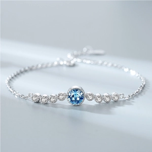 Elegant silver necklace featuring a round blue gemstone pendant with sparkling side stones